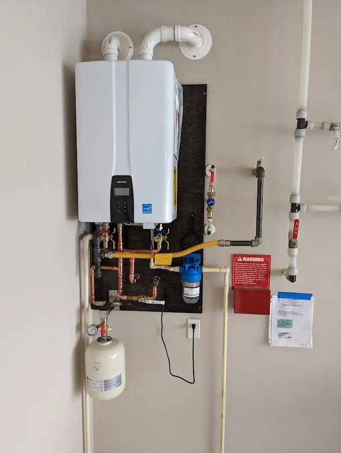 Professional plumber installing copper piping in a Oakville home